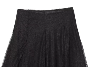 Close-up of black lace skirt showing intricate floral patterns and sheer mesh fabric