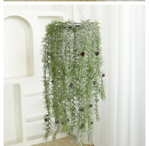 Close-up of hanging pine needle garland with natural pine cones and frosted white tips