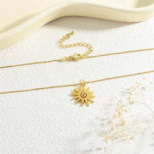 Close-up of golden sun pendant necklace with adjustable chain and lobster clasp