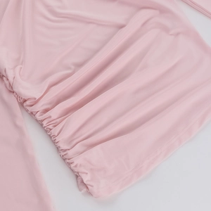Detail view of pink silky fabric featuring elegant pleated texture and soft drape