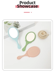 Close-up of pastel handheld makeup mirrors with vintage floral relief frames and handles