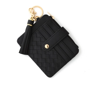 Detail of black woven pattern wallet with gold hardware tassel and snap button closure