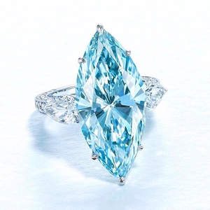 Macro shot of marquise-cut light blue zircon ring with six-prong setting and side accents