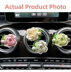 Close-up of four colorful 3D floral air vent clips installed on a car dashboard
