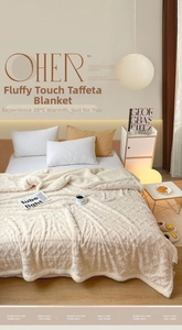Ivory tufted blanket with geometric texture on bed in cozy minimalist bedroom setting