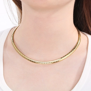 Chic gold-tone stainless steel collar necklace with geometric texture on female model