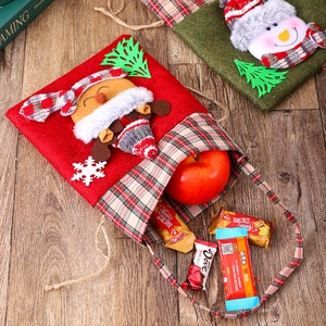 Close-up of festive plaid felt gift bags with 3D reindeer and snowman characters