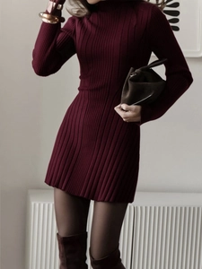 Detail shot of wine red knitted dress fabric showing vertical ribbing texture and slim fit