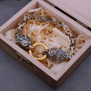 Détail du bracelet tête de loup argentée avec anneau doré dans sa boîte en bois