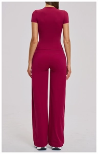 Back view of women's burgundy yoga set featuring fitted t-shirt and wide-leg sports pants