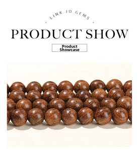 Macro detail of polished dark brown natural sandalwood beads with fine grain texture