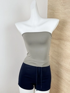 Detail of grey strapless tube top and drawstring shorts on a display mannequin