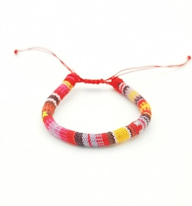 Detailed close-up of a handmade Bohemian woven surf bracelet with colorful threads