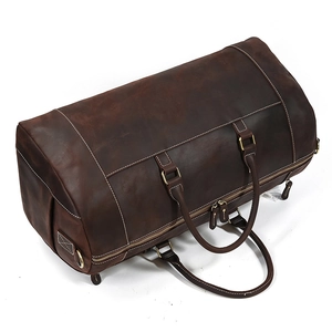 Macro view of dark brown crazy horse leather duffle bag with dual metal zippers