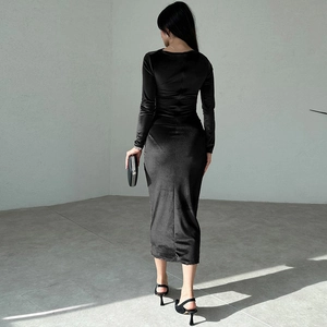 Rear view of sleek black velvet midi dress showing high-quality texture and slim fit