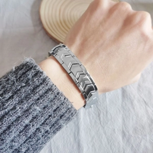 Macro shot of silver titanium steel bracelet with double-row magnets on model's wrist