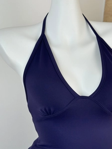 Close-up of deep blue ribbed halter top featuring pleated bust detail on a white mannequin