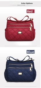 Detail view of red and blue waterproof nylon bags with quilted patterns and zippers