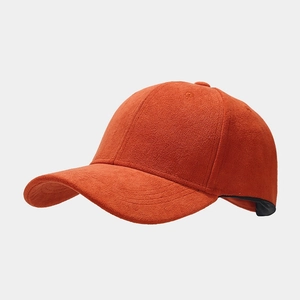 Detailed close-up of orange suede baseball cap showing fine fabric texture and stitching