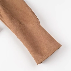 Detailed close-up of brown faux suede cuff with high-quality stitching and smooth texture