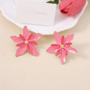 Detail of pink floral double-layer earrings with gold edges on white display tray