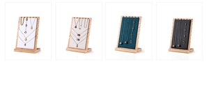 Bamboo and wood jewelry display stand showing four color options for necklaces
