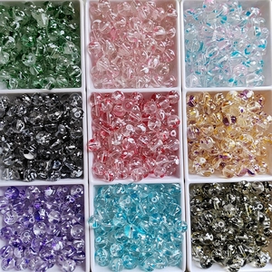Detailed top view of 8-10mm colorful flower glass beads sorted in a white grid organizer