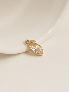 Macro view of 18K gold plated marquise cut zircon pendant charm with dual connection rings