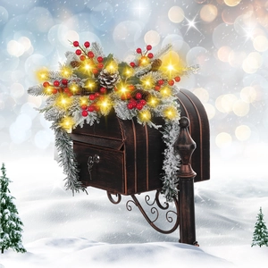 Vintage metal mailbox with Christmas garland decoration and warm LED fairy lights