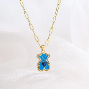 Gold paperclip chain necklace with blue enamel bear pendant and navy heart gemstone