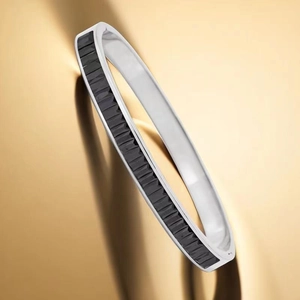 Gros plan sur un bracelet en acier titane argenté orné de pierres rectangulaires noires