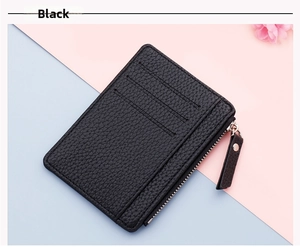 Detail view of black litchi pattern leather slim card holder with zipper and card slots