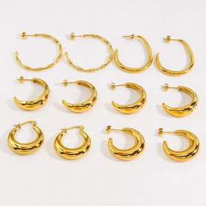 Set of gold stainless steel hoop earrings with colorful zircon stones on white background