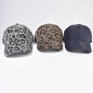 Stylish leopard print baseball caps shown in black, gold, and blue textured fabric