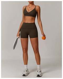 Detail of high-stretch matte olive green sports bra and high-waist shorts set for fitness