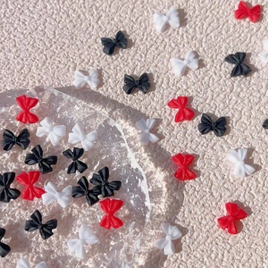 Mix of small matte resin bow nail charms in red, black, and white for DIY manicure art