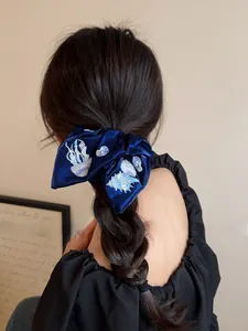 Detailed embroidery of marine life on premium velvet bow hair scrunchie for low ponytail