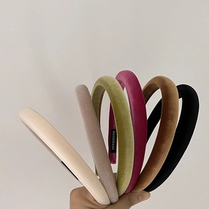 Close-up of six premium velvet headbands in assorted colors with handmade label details