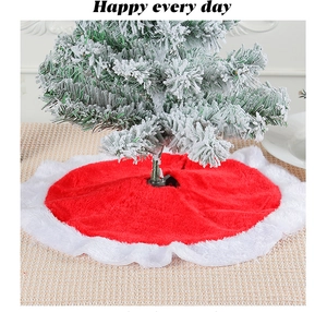 Detailed view of plush red Christmas tree skirt with white border on a woven mat