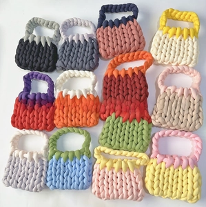Close-up of handmade chunky knit handbags in various vibrant candy colors and patterns