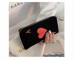 Detail of Ace of Hearts canvas wallet featuring a gold zipper and embroidered pattern
