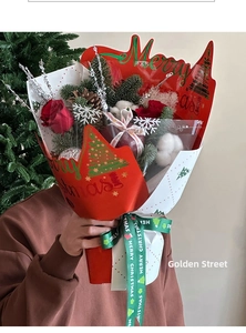 Christmas bouquet gift wrap featuring red roses, pine cones, and Merry Christmas pattern