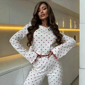 Women's pajama set featuring flared sleeves and red heart prints on a white fabric
