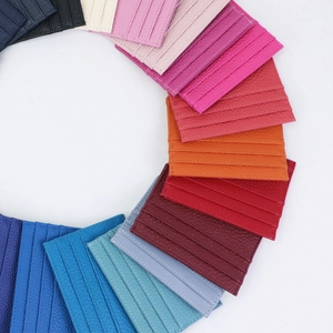 Detailed overhead view of pebbled leather card holders in various vibrant colors