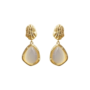 Elegant gold drop earrings with cream white gemstones and irregular relief texture details