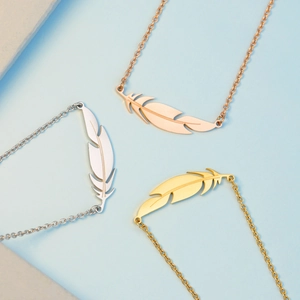 Three-tone feather pendant necklace in gold, silver, and rose gold stainless steel