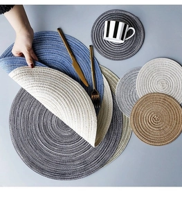 Close-up of woven round placemats in various colors showing texture and flexibility