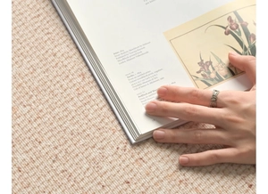 Close-up of vintage marcasite ring with knot design worn over an open art book