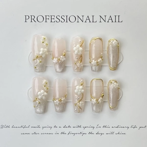 Handmade almond press-on nails with pink cat eye effect and 3D floral pearls design