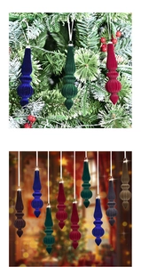 Close-up of velvet spindle Christmas ornaments hanging on a festive decorated tree branch